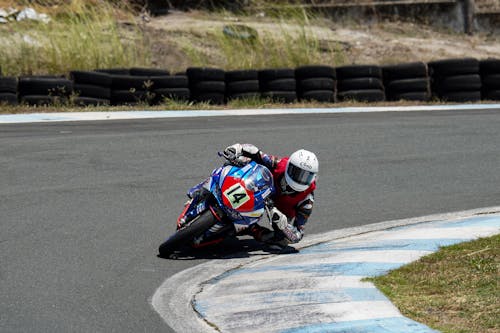 Man Wearing Racing Suit Riding a Sports Bike · Free Stock Photo