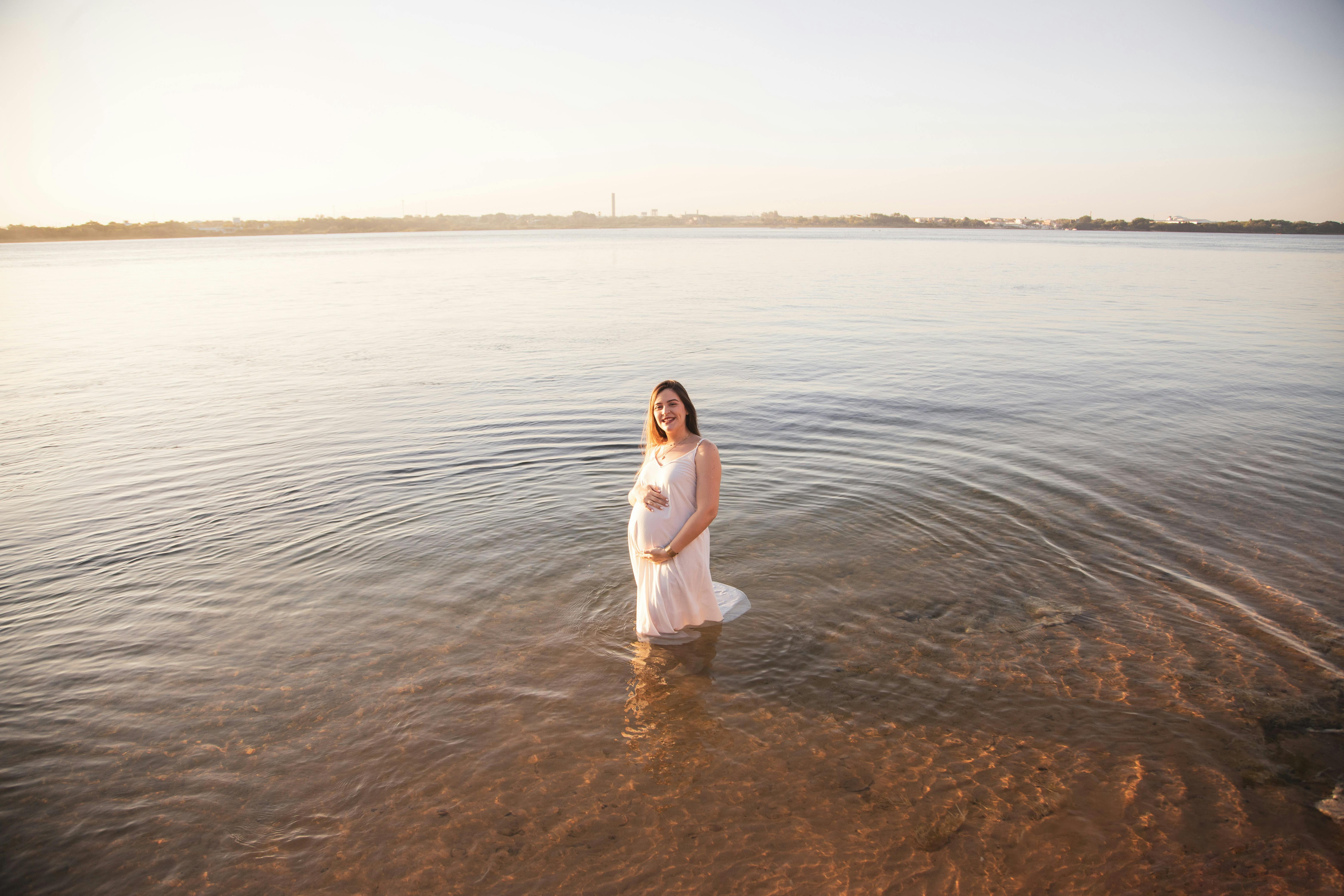 a pregnant woman standing in the water