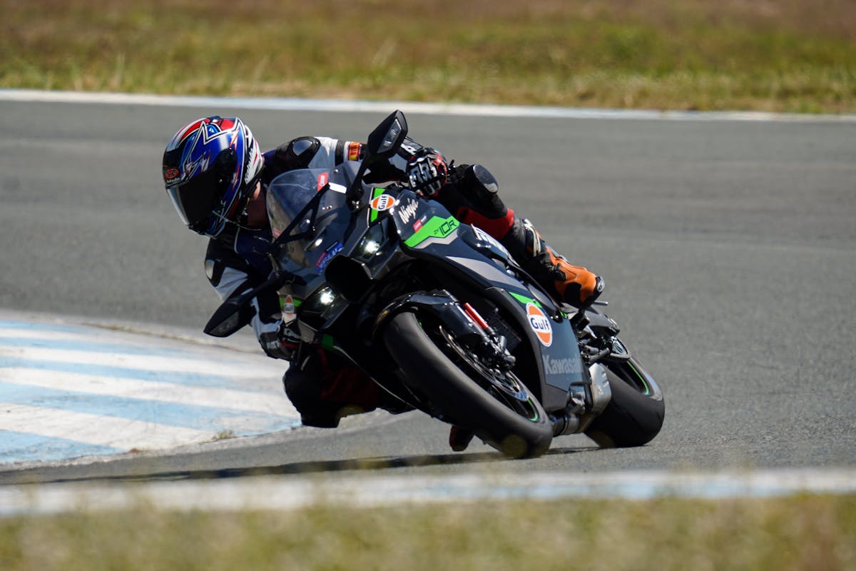 A Racer Riding His Motorcycle in the Race Track · Free Stock Photo