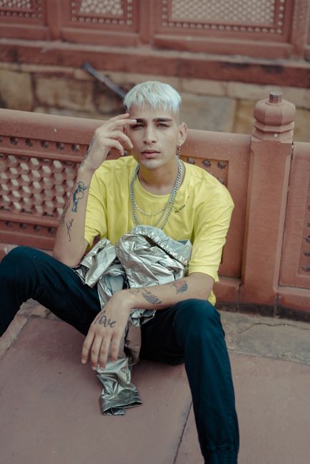 Portrait of a stylish young man with tattoos, posing outdoors in New Delhi.