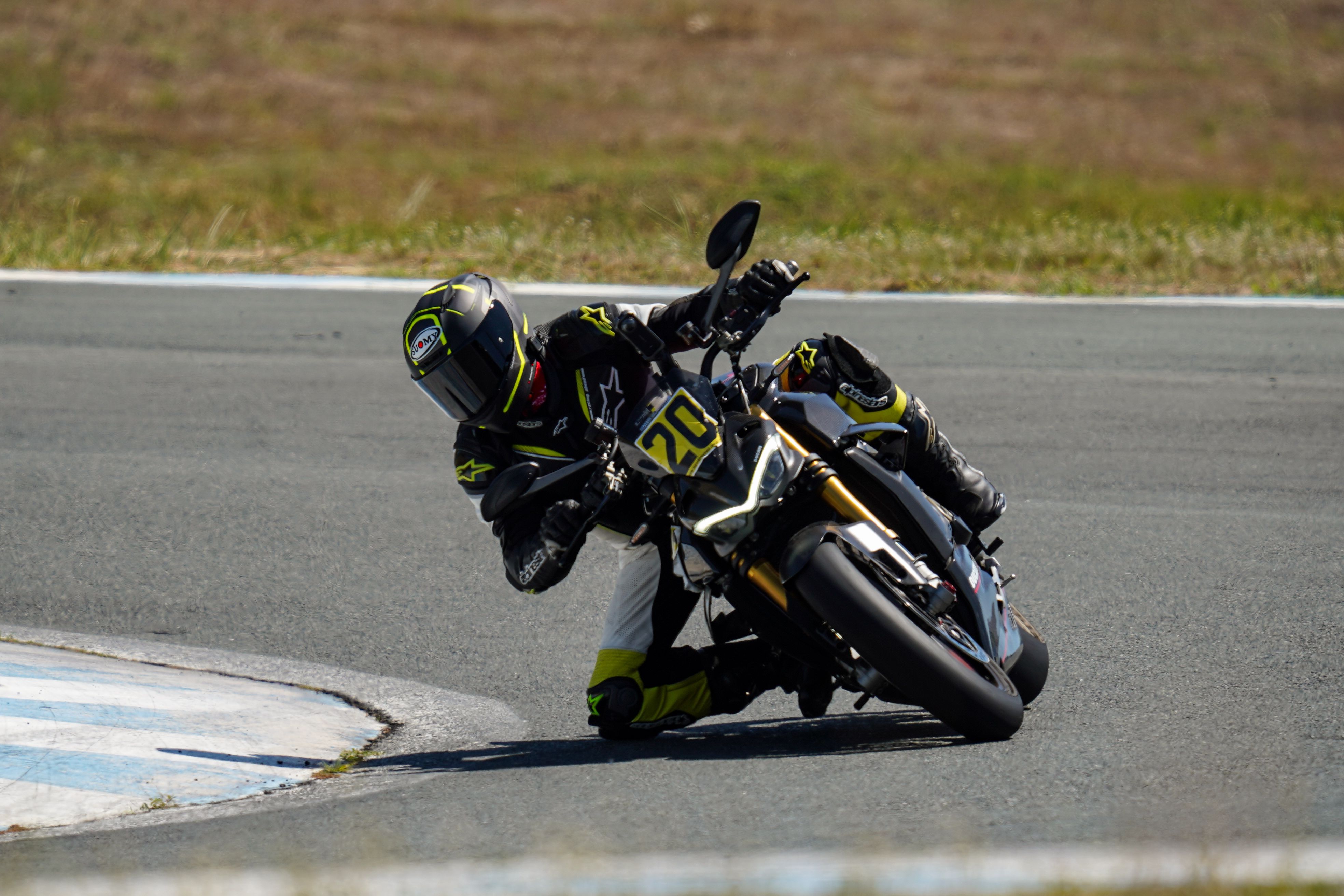 A person riding a motorcycle on a race track · Free Stock Photo