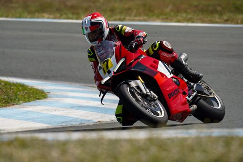 Free Motorcycle racer leaning into a fast turn on a race track in Central Luzon, Philippines. Stock Photo
