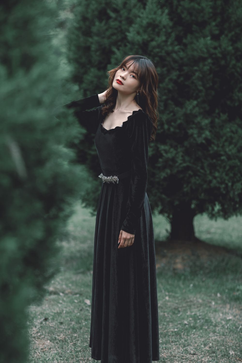 A woman in a black dress standing in the woods · Free Stock Photo
