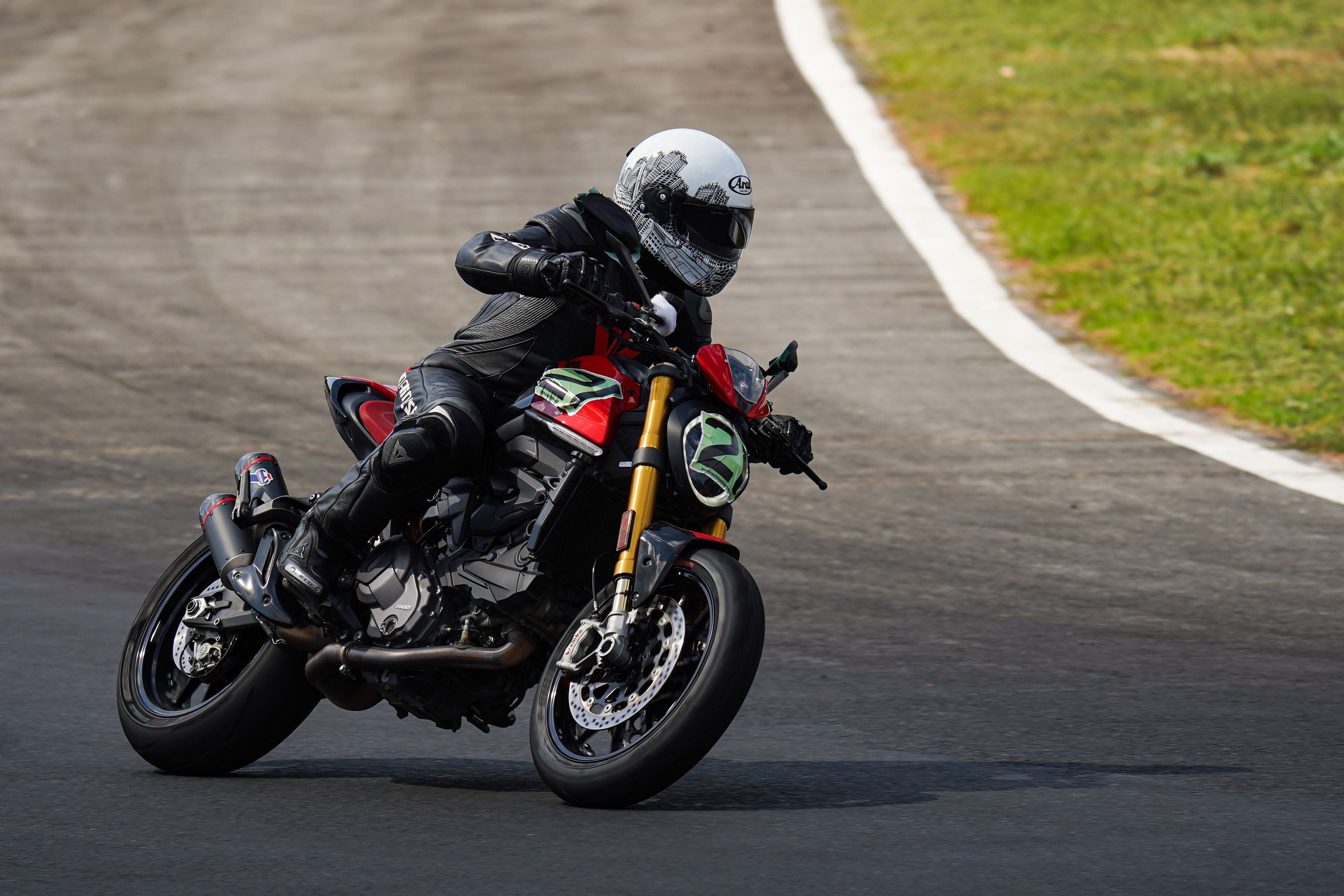 A person riding a motorcycle on a race track · Free Stock Photo