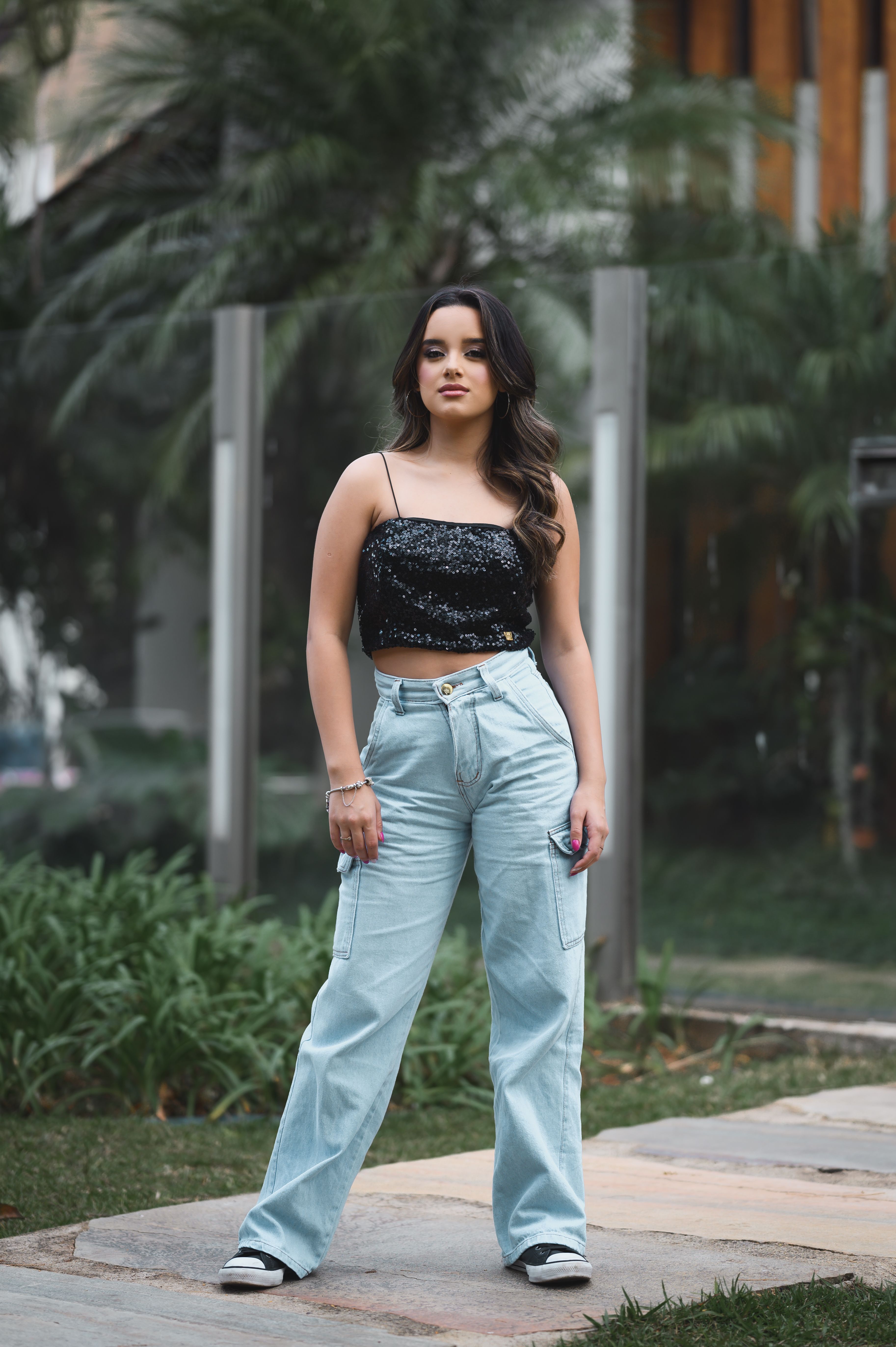 Woman in sequin top with jeans party outfit