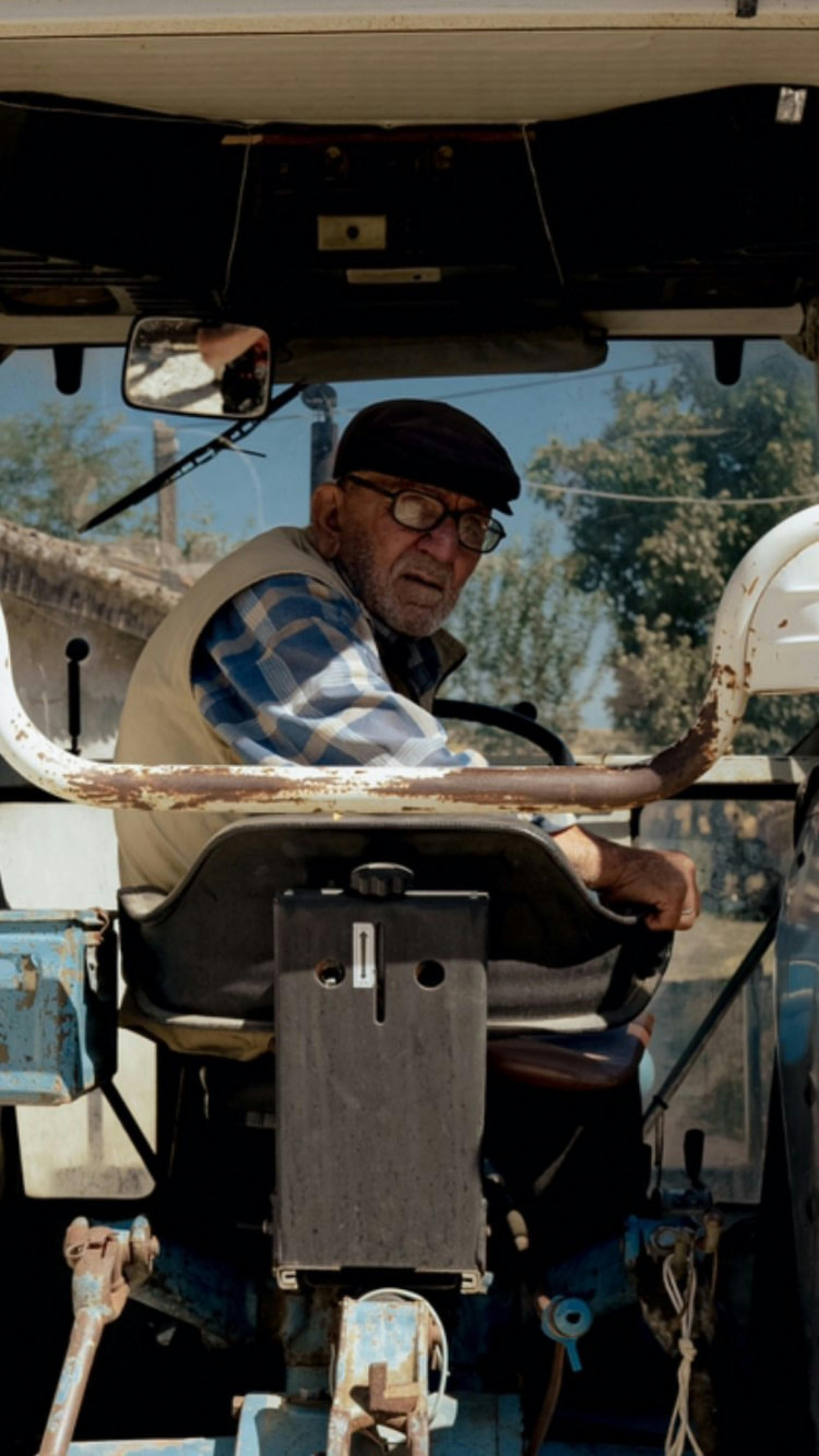 a man sitting in the driver s seat of a tractor