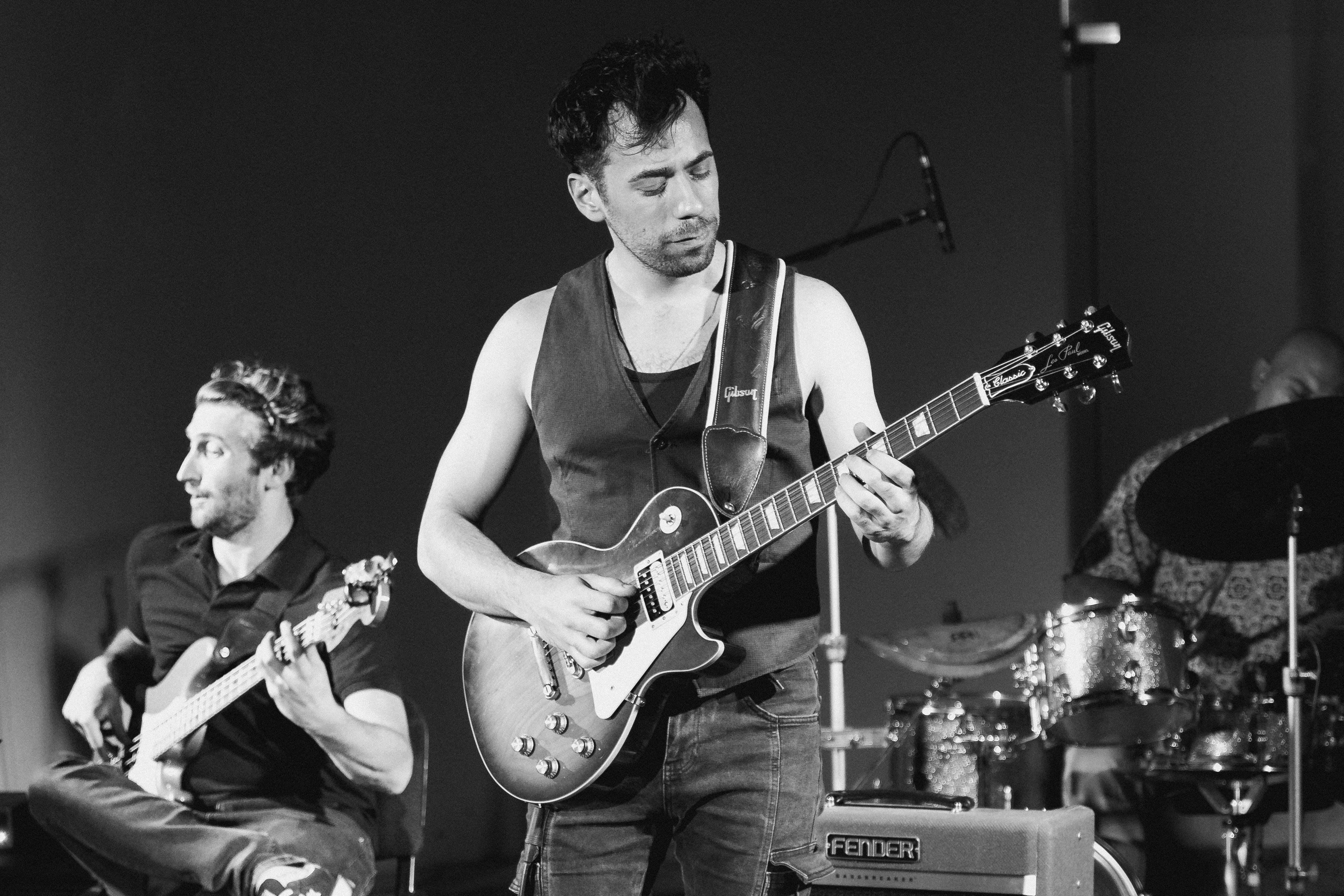 Dynamic black and white image of a live jazz band performing on stage.
