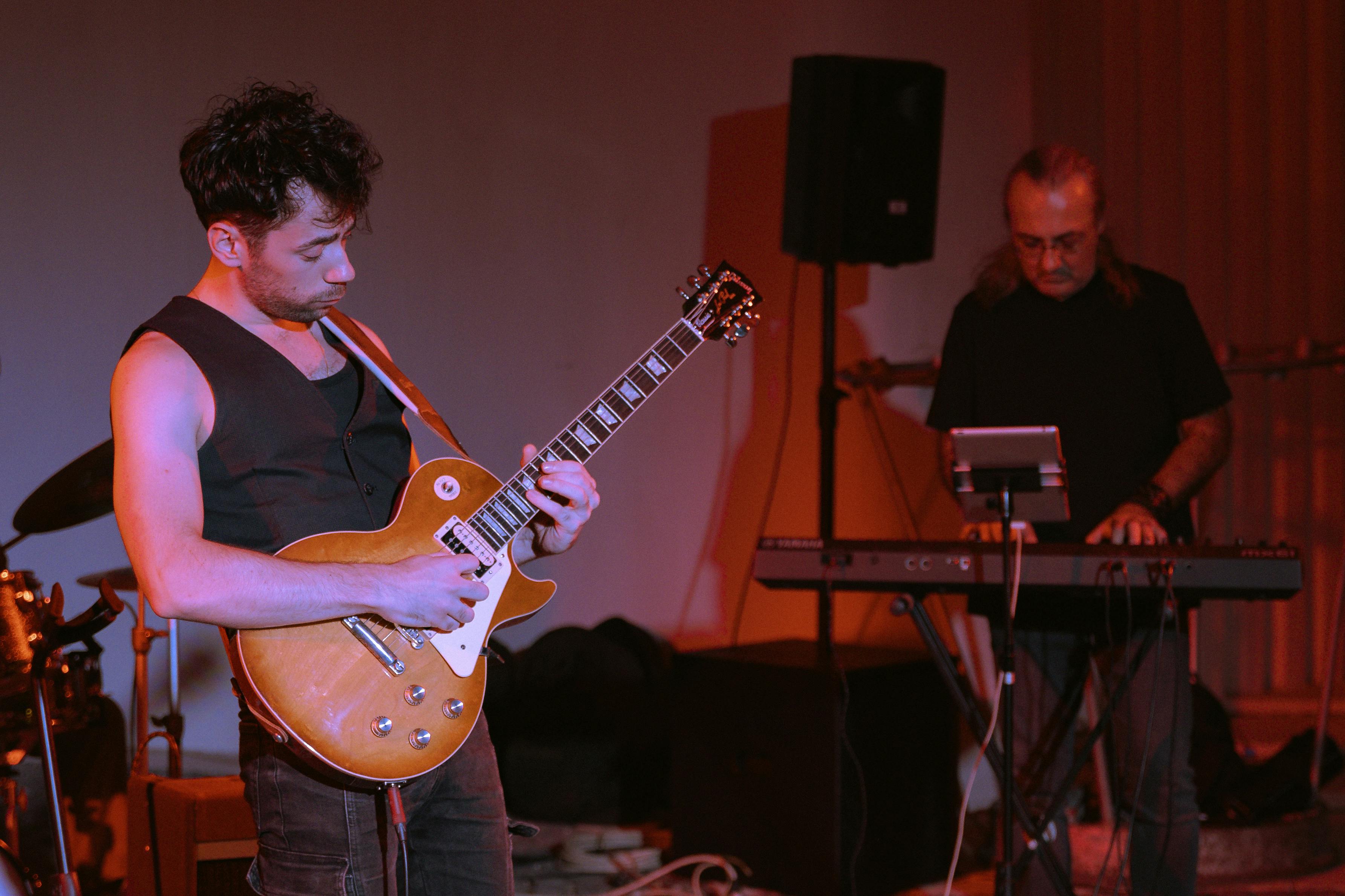 a man playing an electric guitar on stage