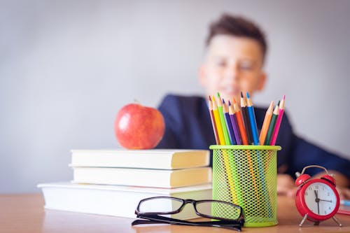 Boy Looking On A Tidied Desk 