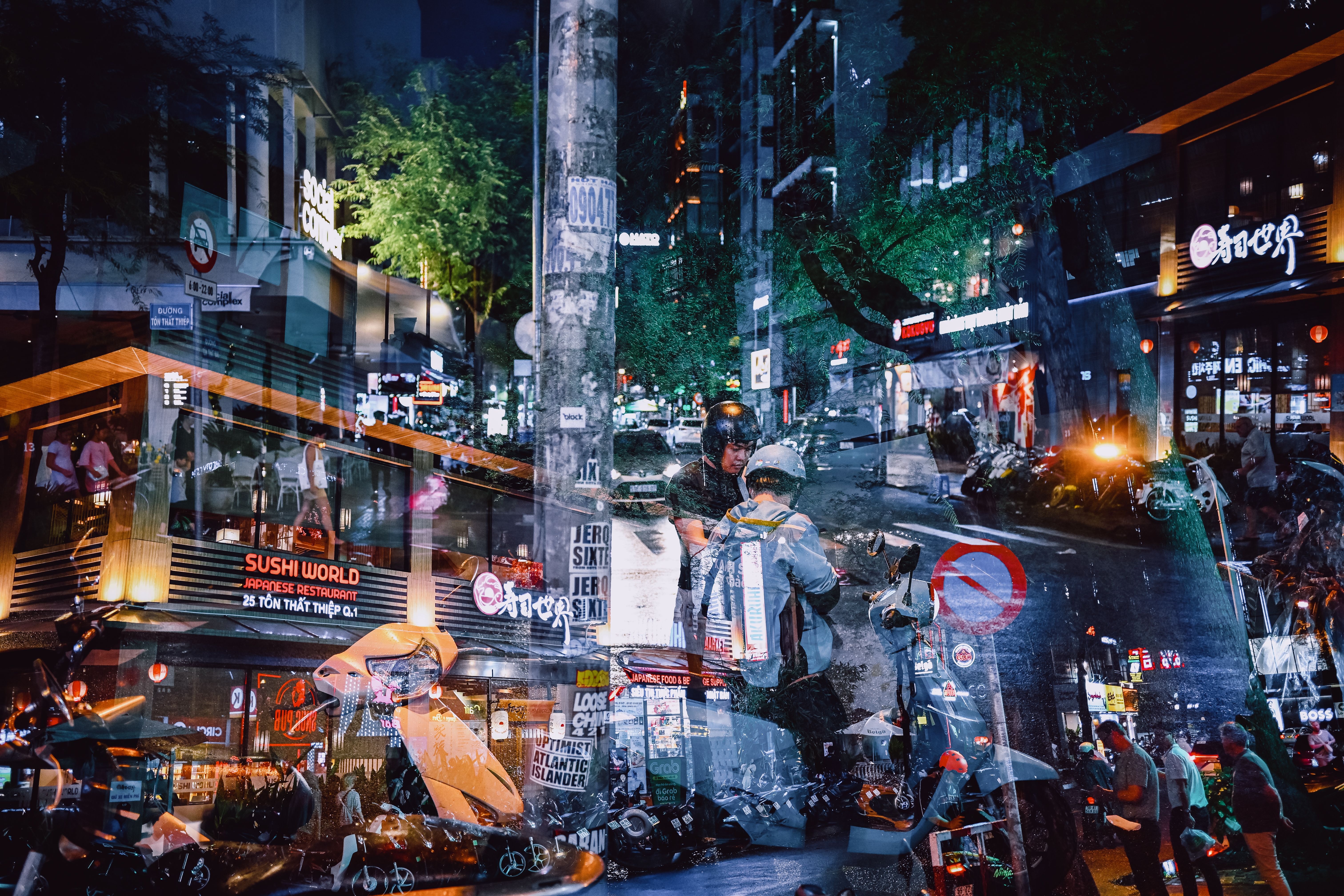street view in District 1 Ho Chi Minh City with neon signs and motorbikes