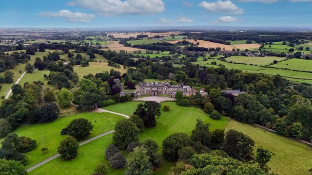 Aerial view of an English country estate with house, gardens and surrounding fields, illustrating the SDLT mixed-use grounds question