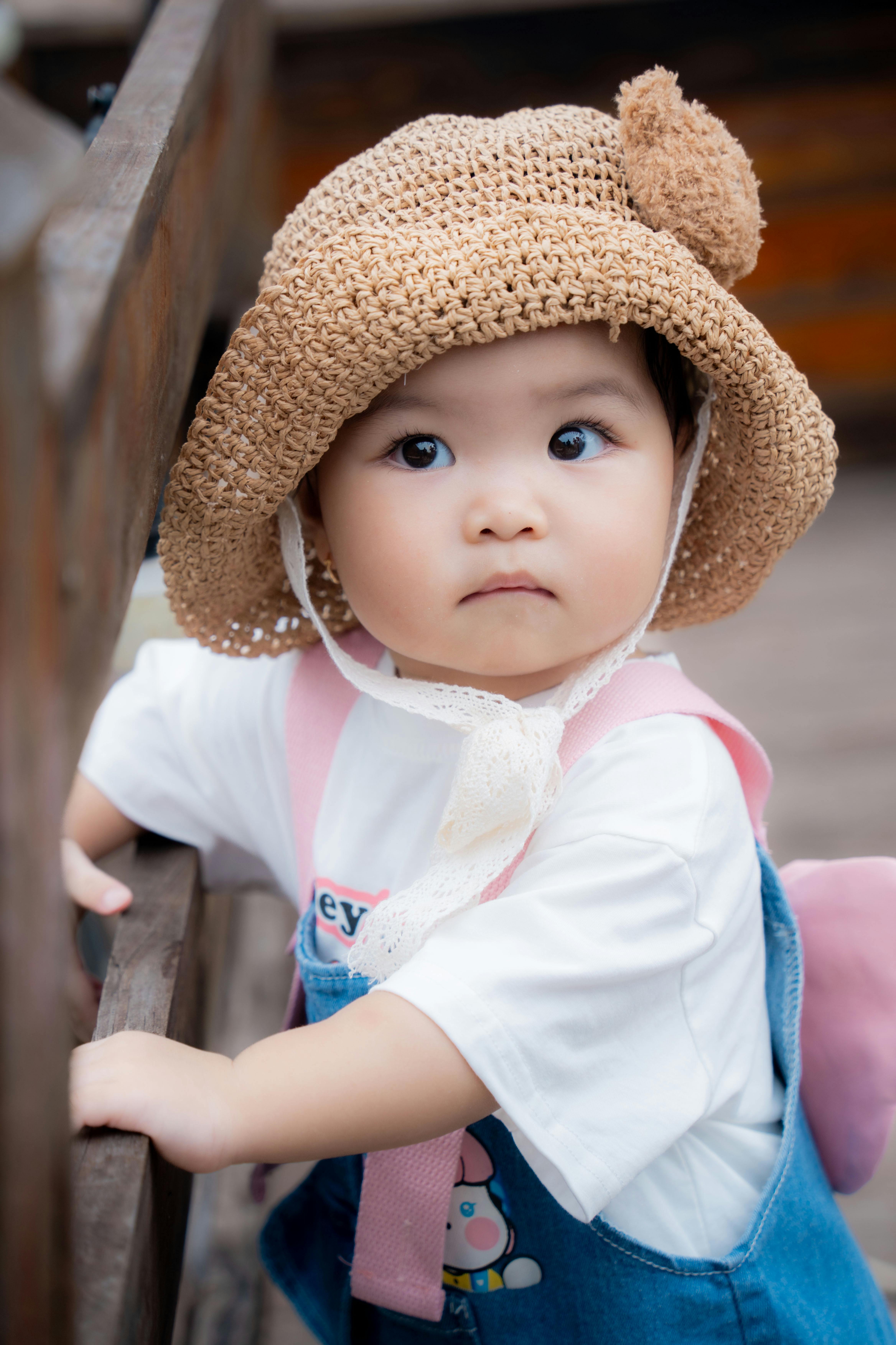 Free Infant Girl Climbing Wooden Fence Looking Stock Photo