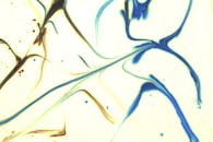 A close up of a painting with blue and white swirls
