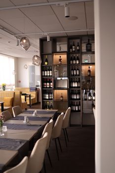Luxurious dining room featuring a contemporary wine display and elegant table settings.