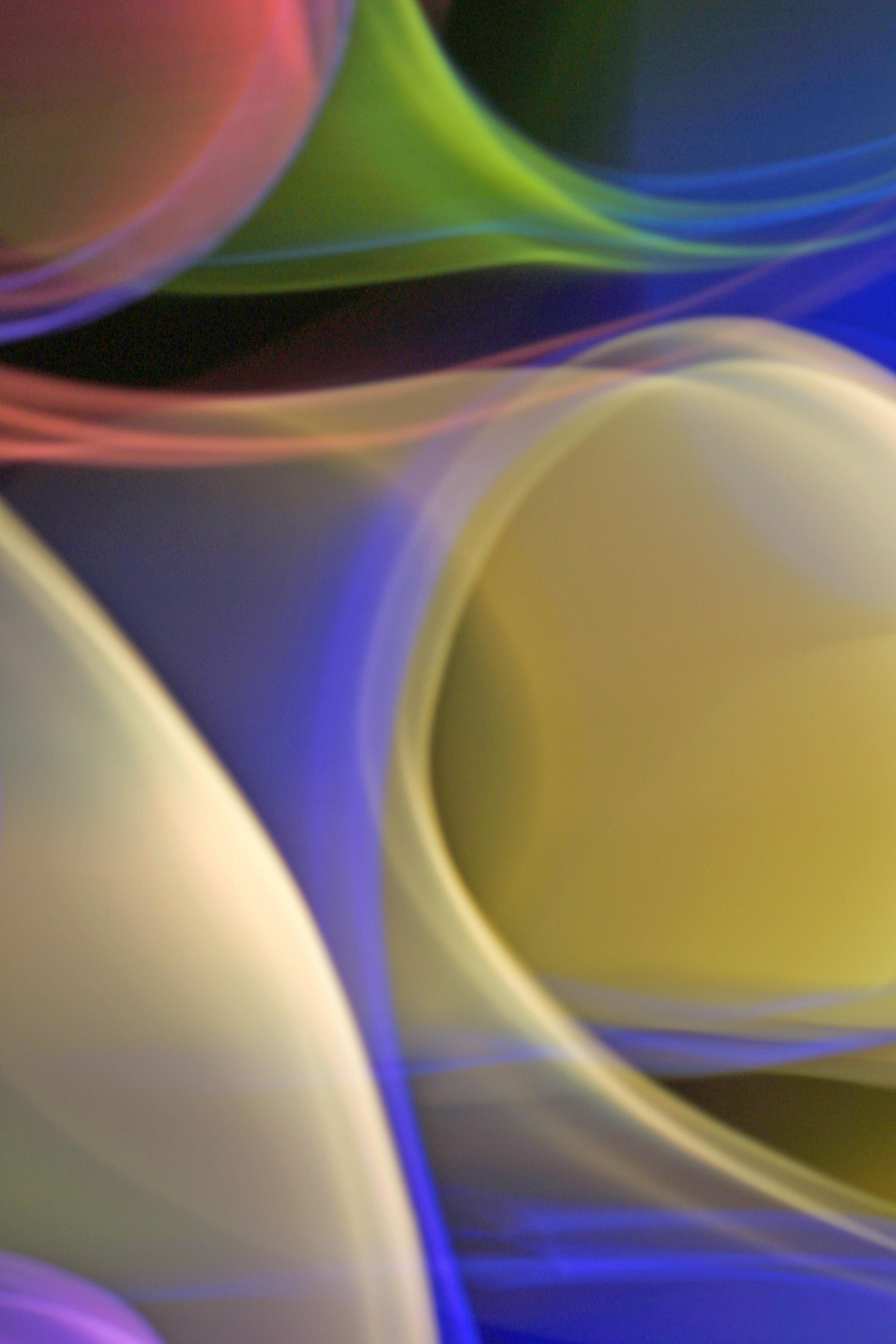 Dynamic abstract light waves with vibrant color gradients and flowing curves.