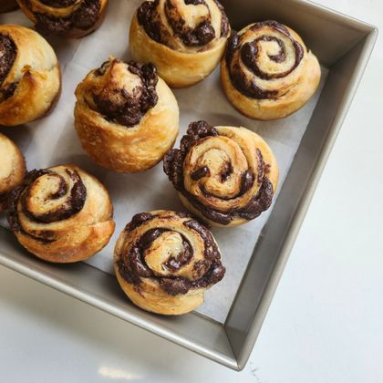 Freshly baked swirl pastries in a pan, photo by Denise Ailin on Pexels