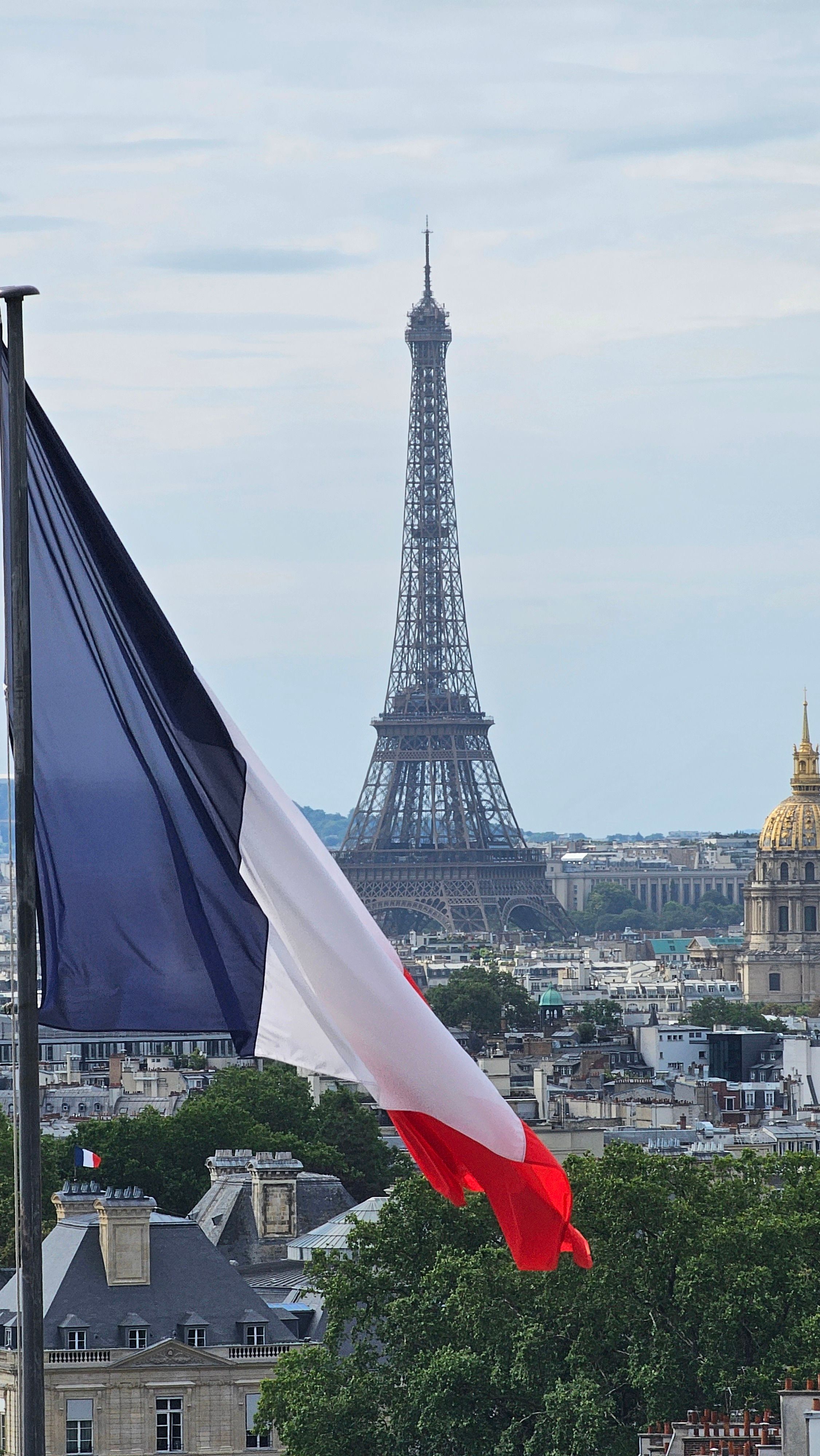 Stunning view of the Eiffel Tower framed by a French flag, capturing the essence of Paris.