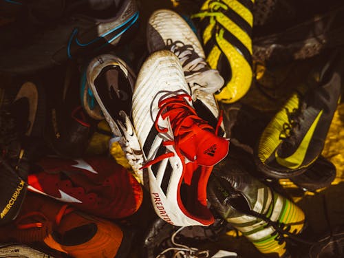 Free A pile of vibrant and colorful sports sneakers highlighting diverse designs and patterns. Stock Photo