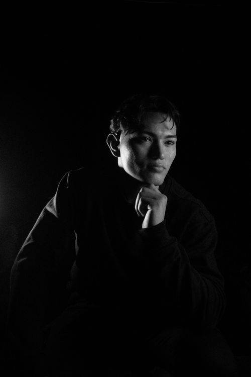 Free Moody black and white portrait of a contemplative man in studio lighting. Stock Photo
