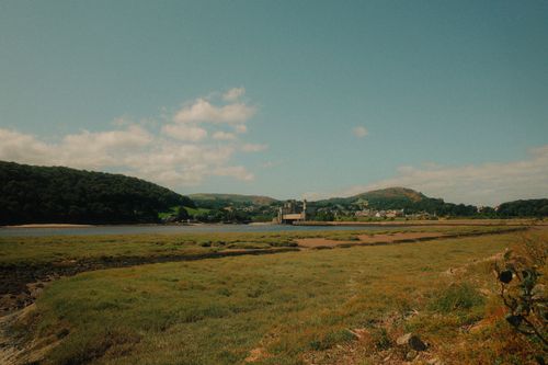Free Picturesque view of Conwy's lush countryside with hills and a castle in Wales. Stock Photo