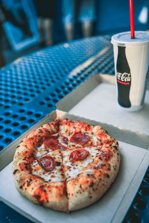 Pizza Beside a Cola Drink