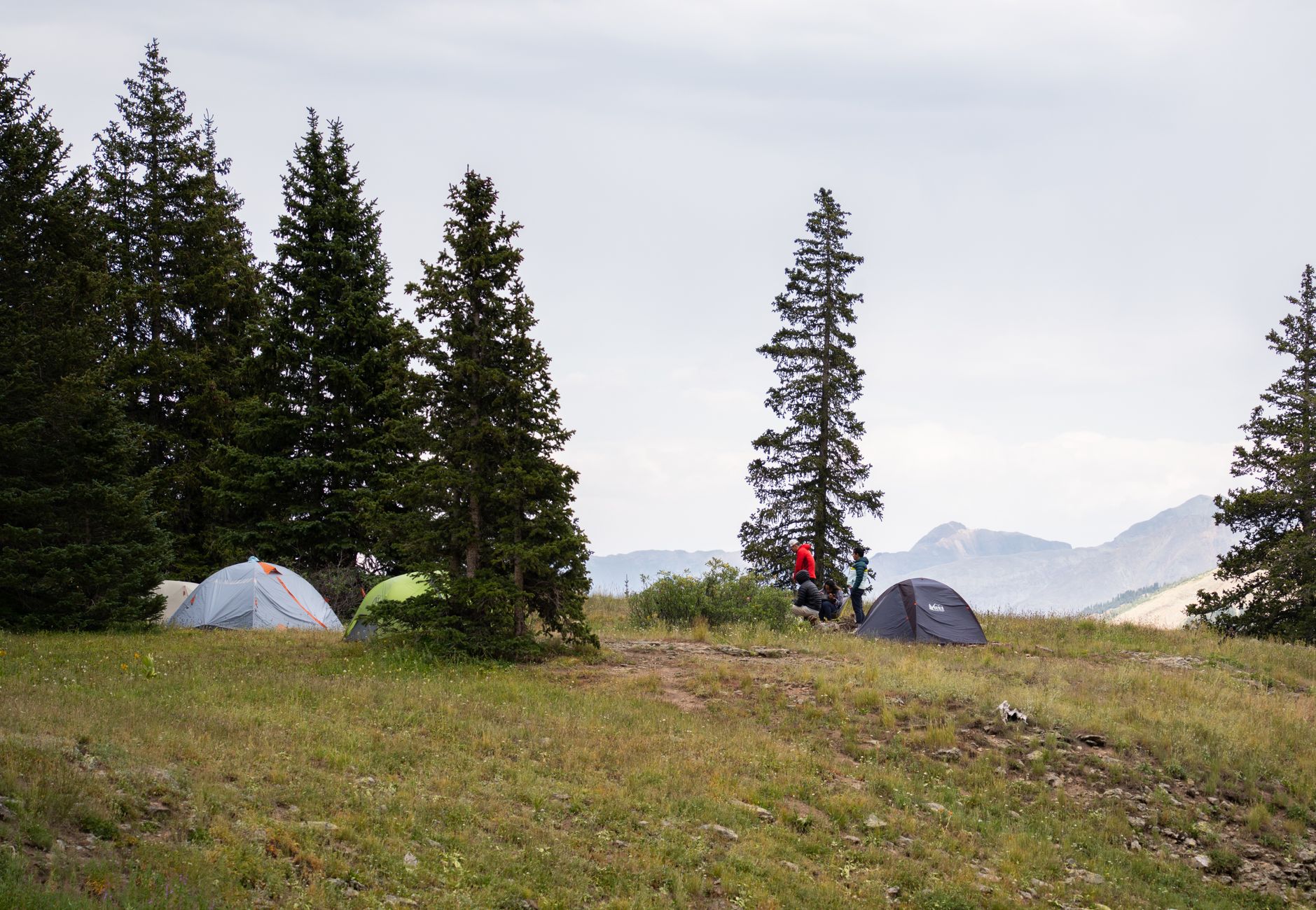hiker setting up tent wilderness