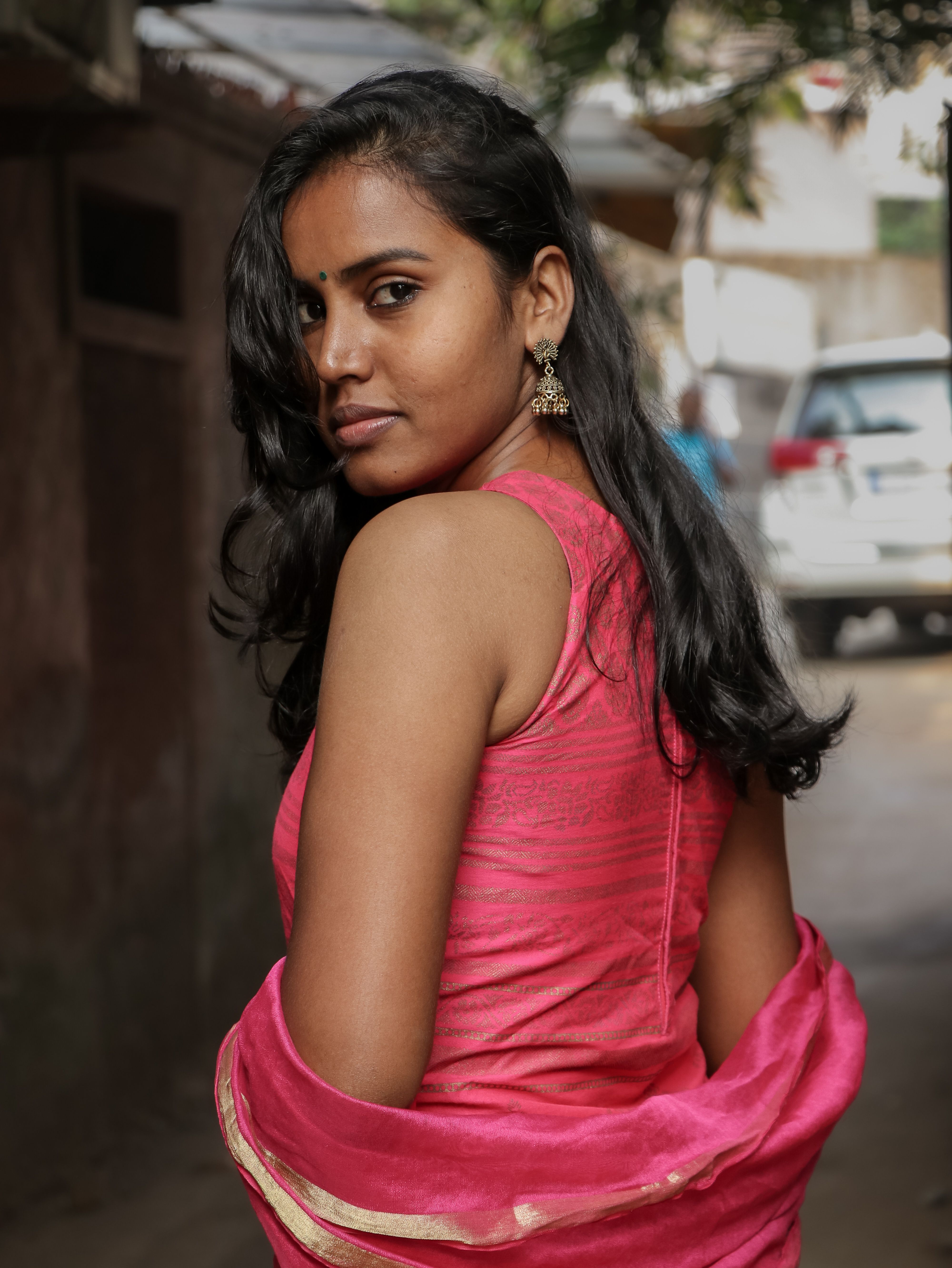 A woman in pink dress posing for the camera · Free Stock Photo