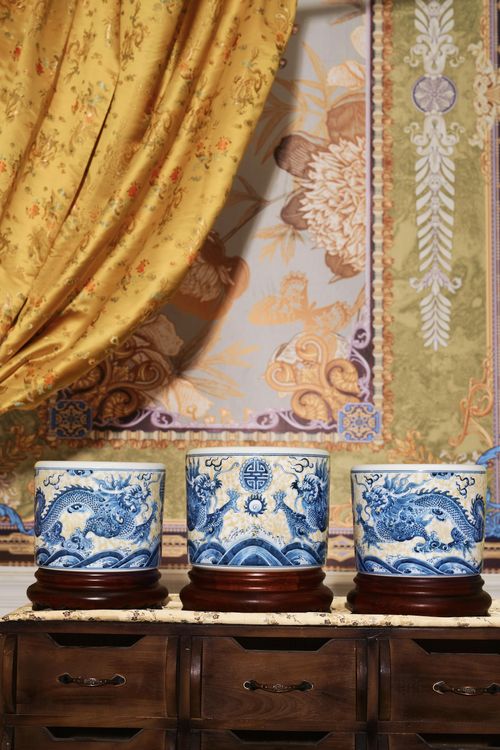 Free Three ornate blue and white dragon vases on wooden stands in a traditional setting. Stock Photo