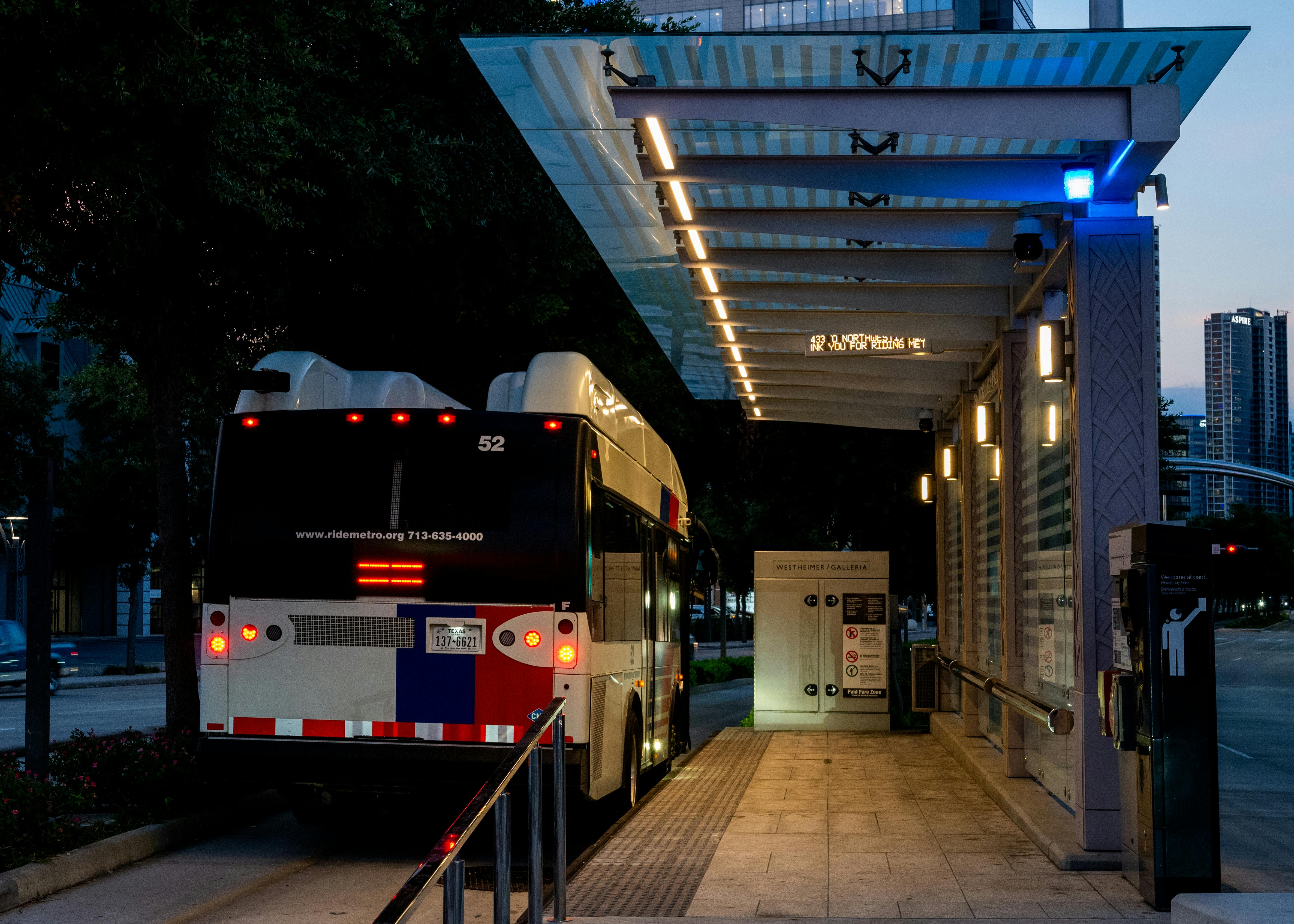 a bus is parked at a bus stop at night