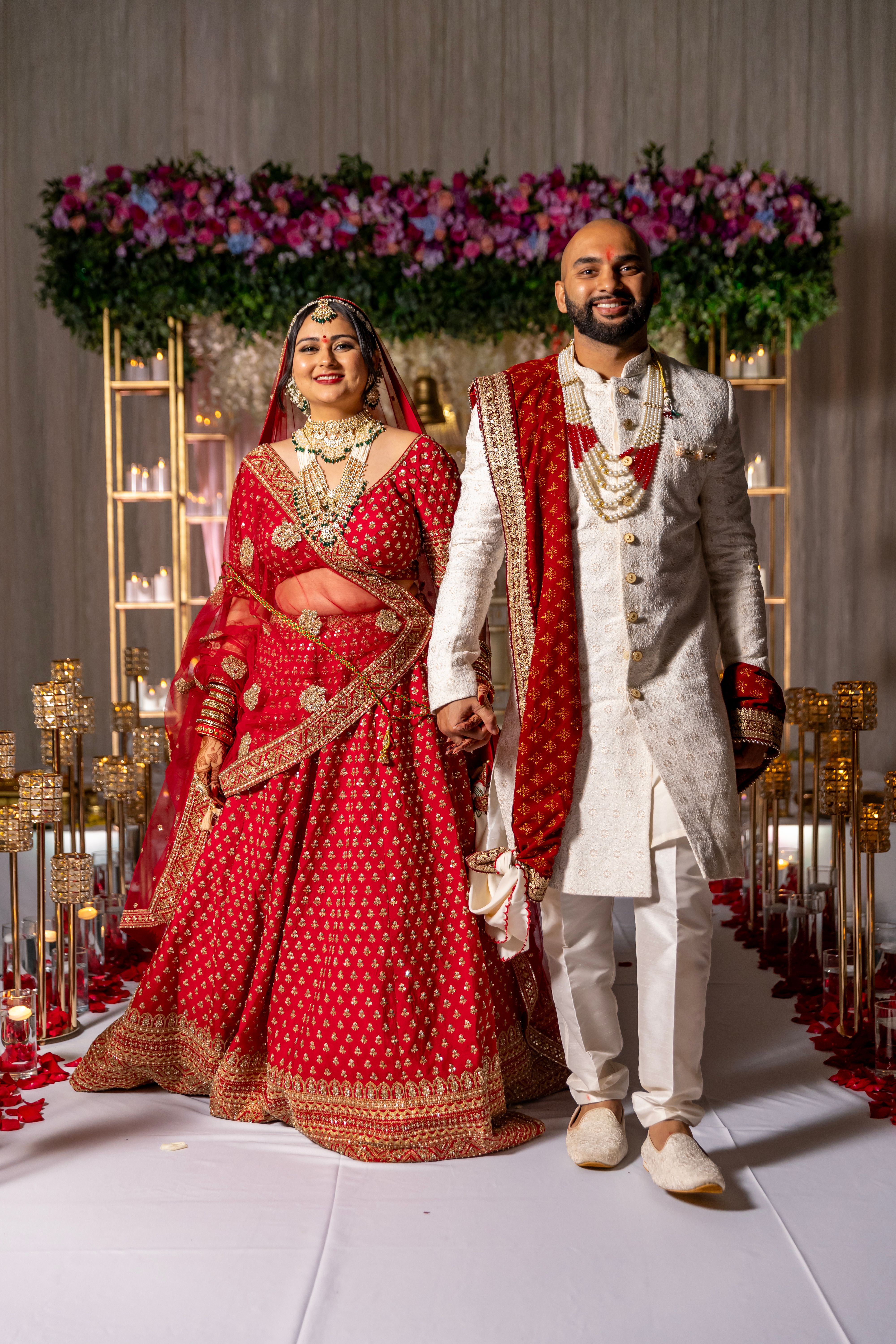 A couple in traditional indian attire walking down the aisle · Free ...