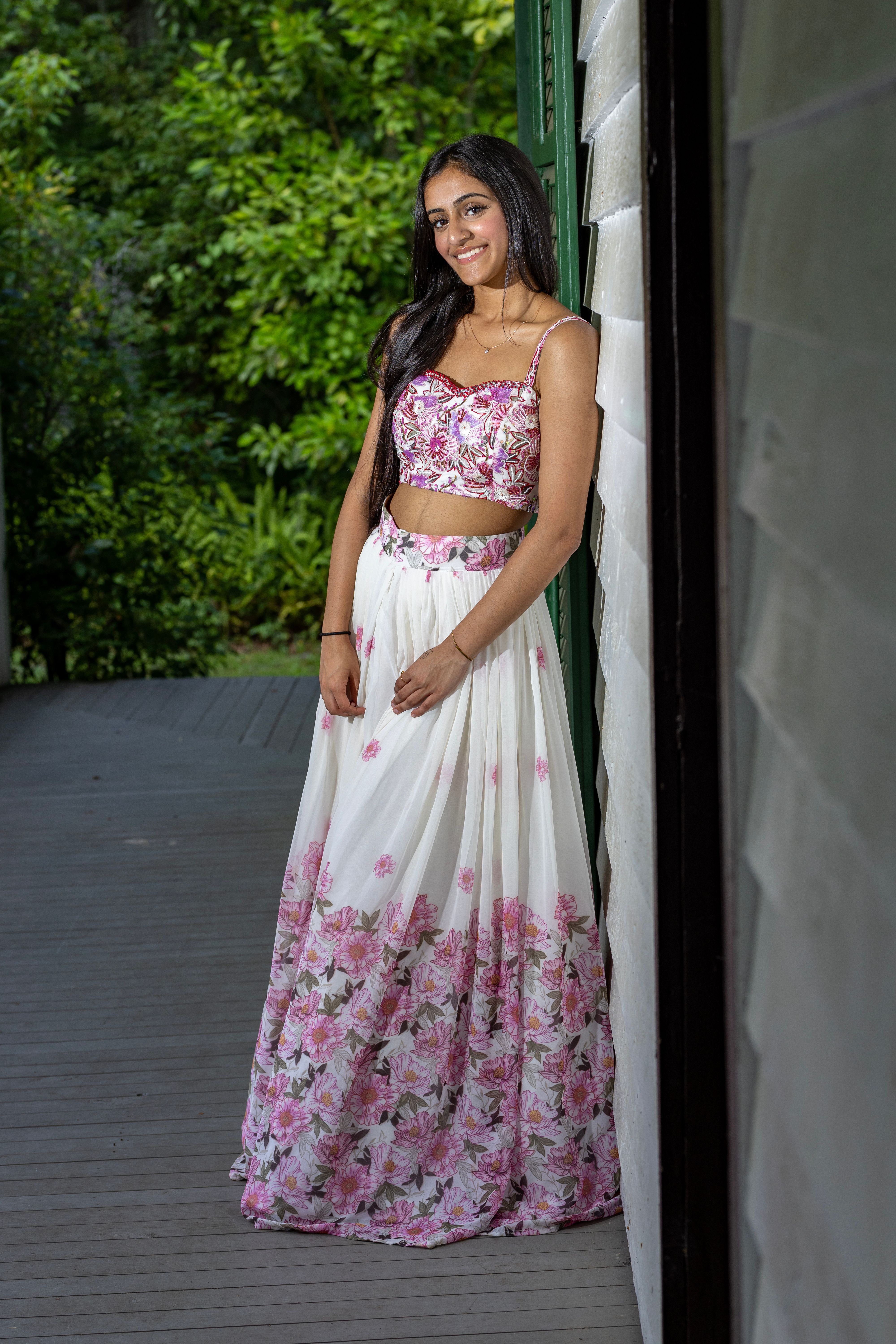 A woman in a pink and white floral skirt · Free Stock Photo