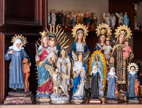Vibrant display of religious statues in a shop in Jardín, Colombia, showcasing traditional Catholic icons and art.