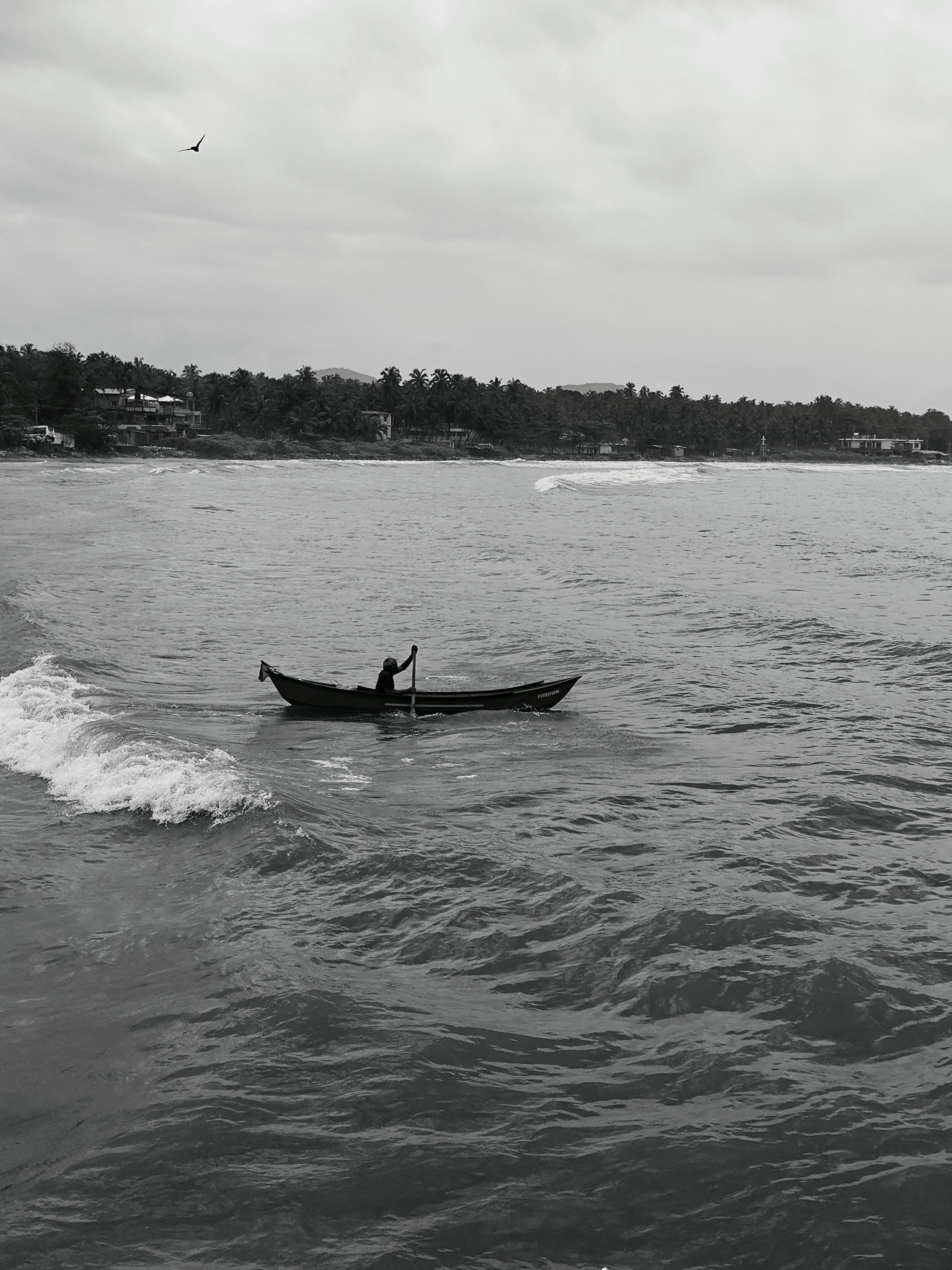A man in a small boat on the ocean · Free Stock Photo