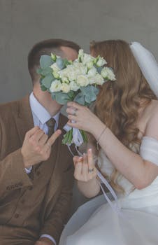 A humorous wedding photo of a couple hiding behind a bouquet, adding a playful touch to their special day.