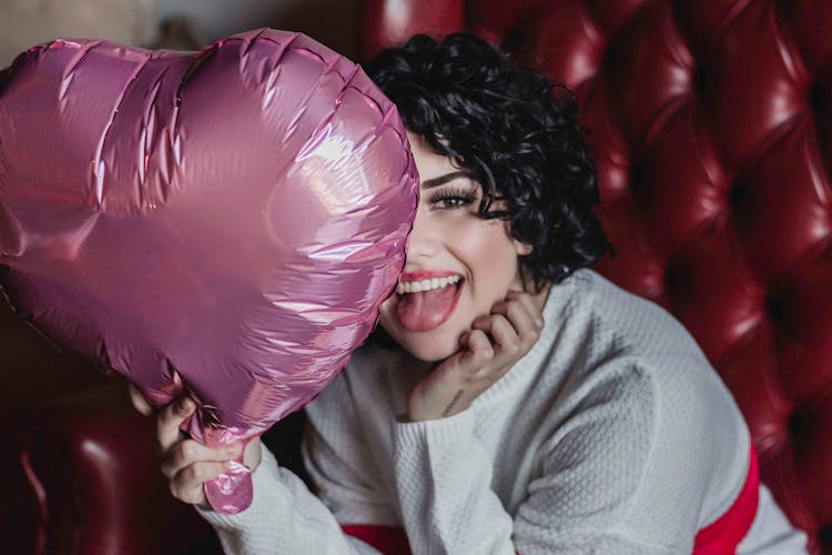 Photo Of Woman Holding Pink Heart Balloon