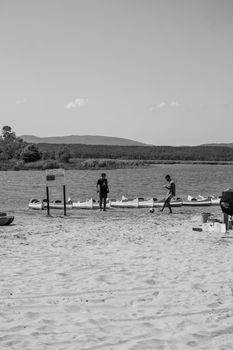 Black and white image of people at a sandy beach in Kırklareli, Türkiye.