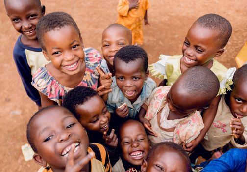 A group of happy children playing outdoors in Kigali, Rwanda, capturing joyful expressions and vibrant smiles.