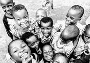 A group of smiling children in Kigali, Rwanda, capturing a moment of pure joy and happiness.