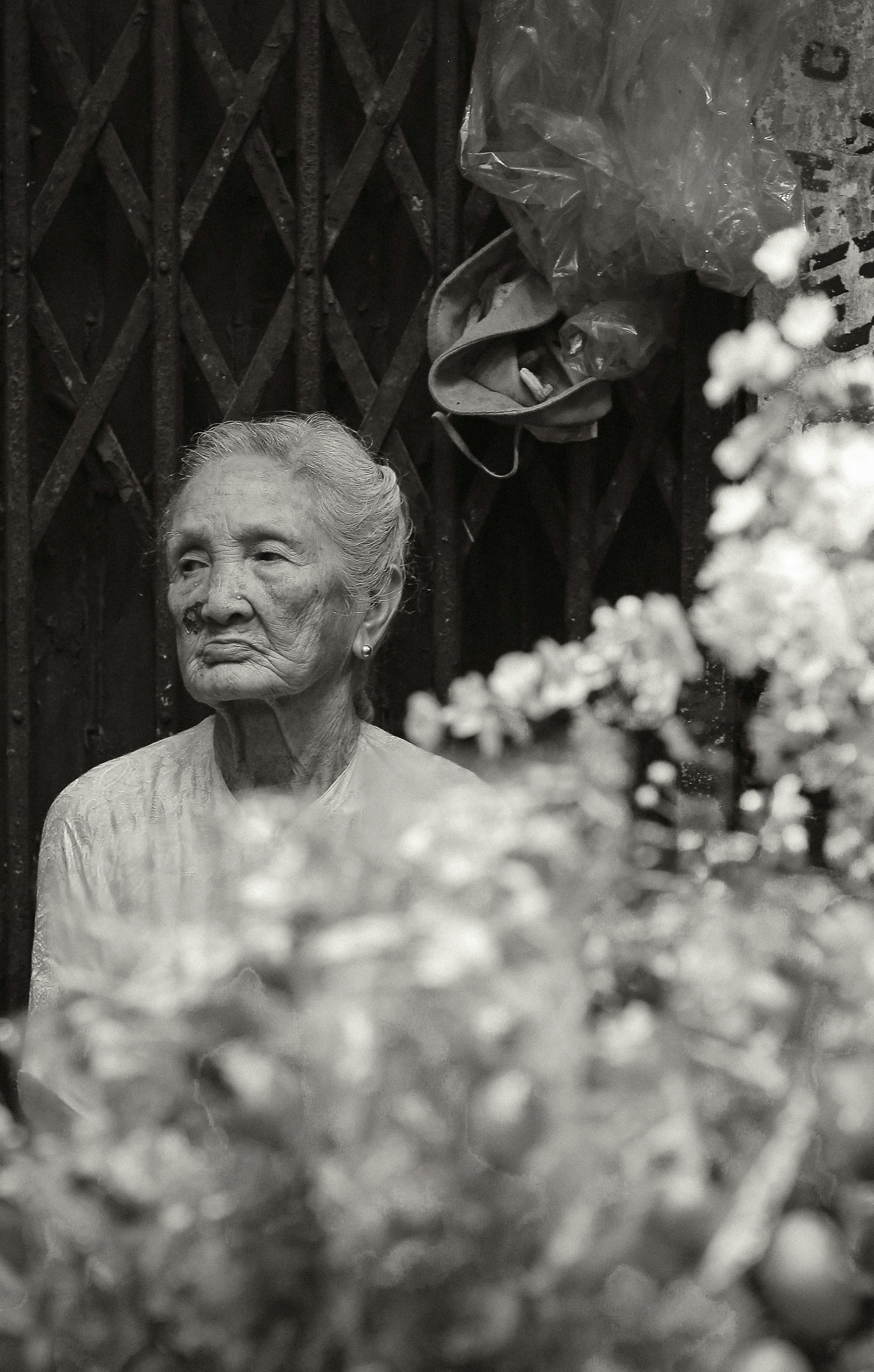 Black and white portrait of an elderly woman in Hanoi, capturing cultural essence and timeless beauty.