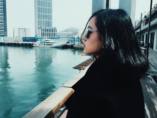 Woman Wearing Sunglasses Looking Towards Body of Water