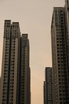 Tall modern skyscrapers dominate the city skyline under a serene dusk sky.