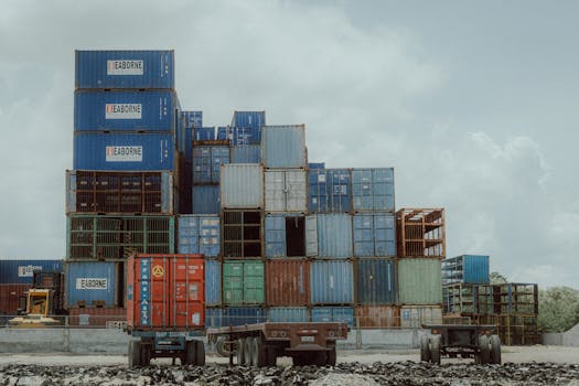 Colorful shipping containers stacked at a port, illustrating global logistics and commerce.