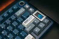 A close up of a blue keyboard with a blue key