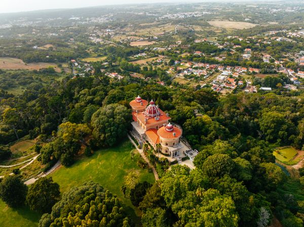 Hilltop palace surrounded by wooded parkland — Matej Simko on Pexels