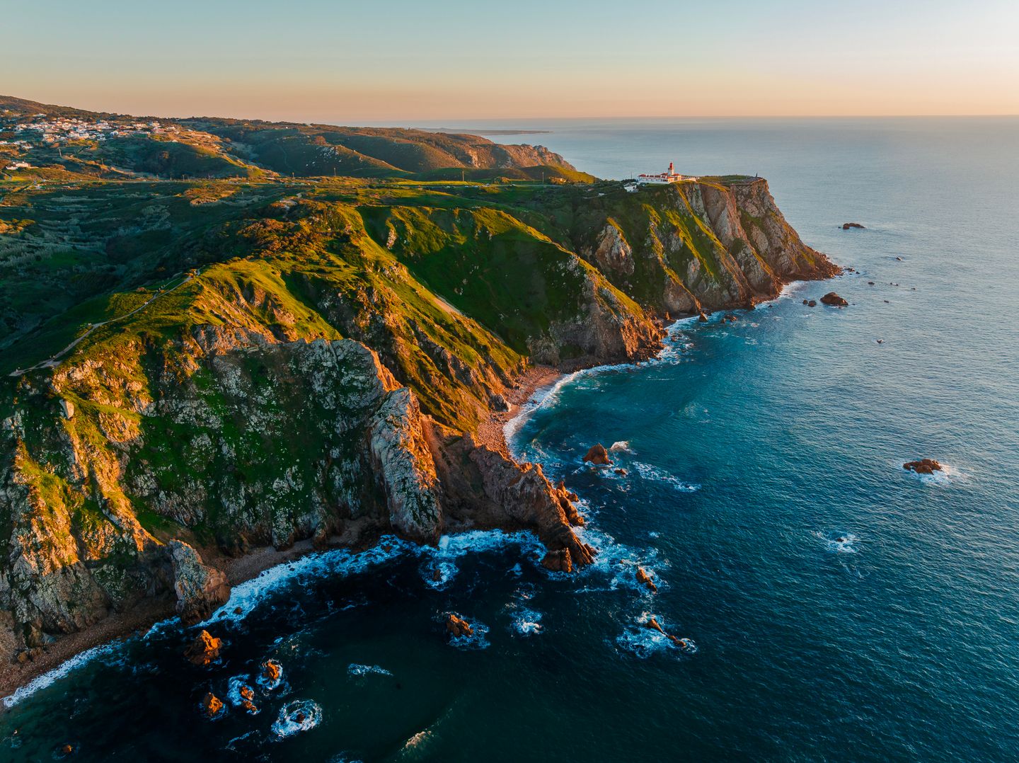 Explore the breathtaking coastal cliffs near Lisbon, Portugal, captured beautifully at sunset.