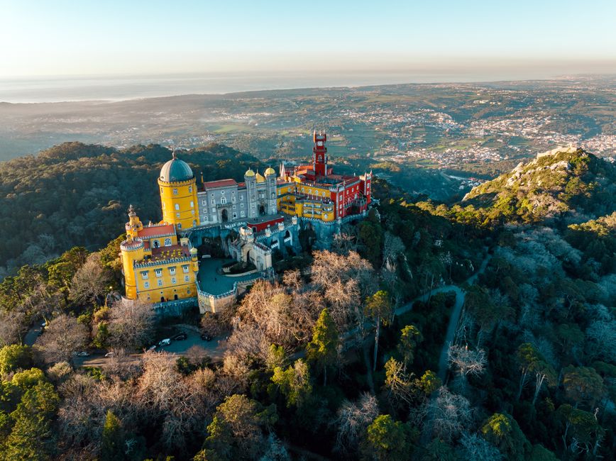 Colorful Pena Palace in Sintra, Portugal, surrounded by lush greenery