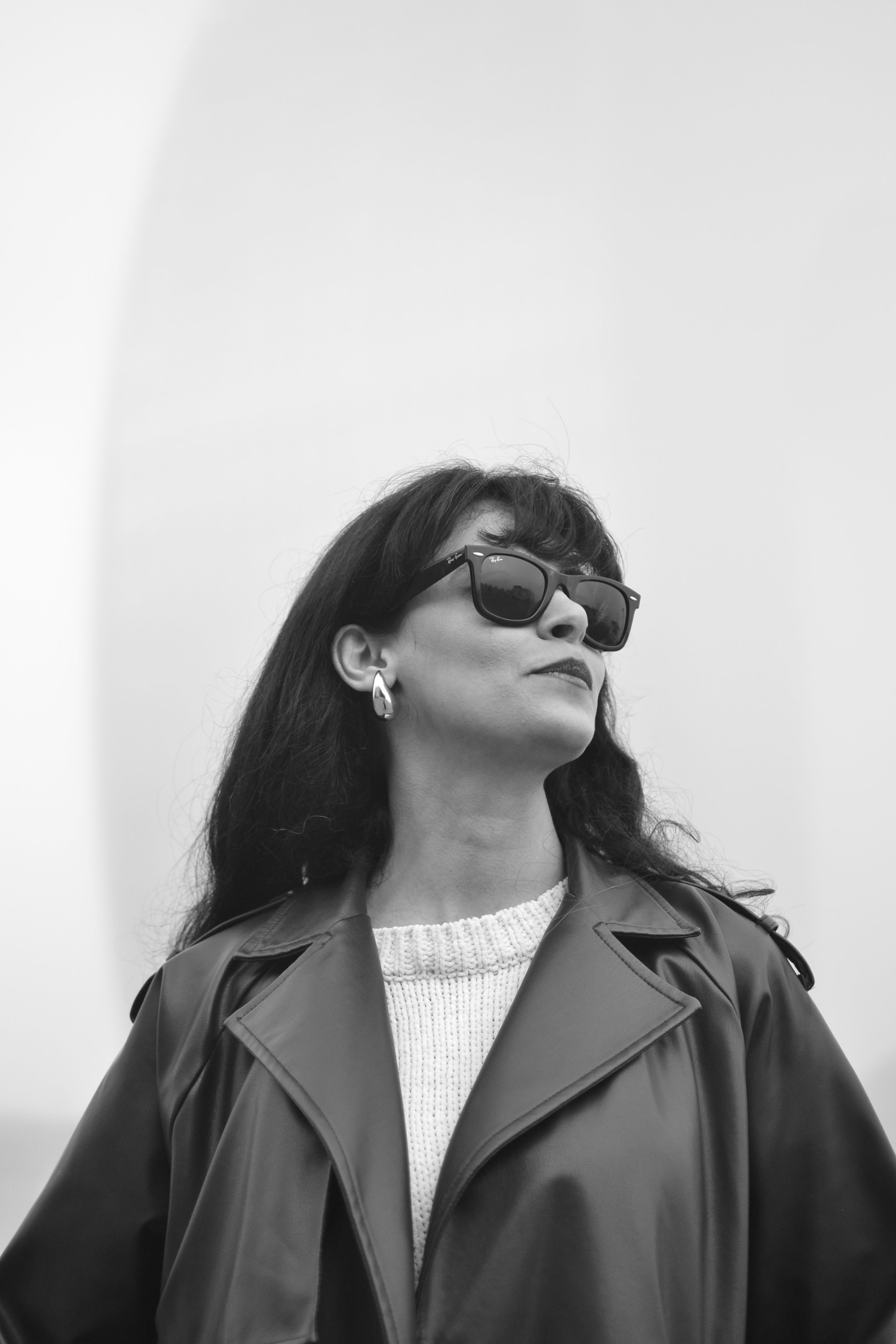 A woman in sunglasses and a trench coat · Free Stock Photo