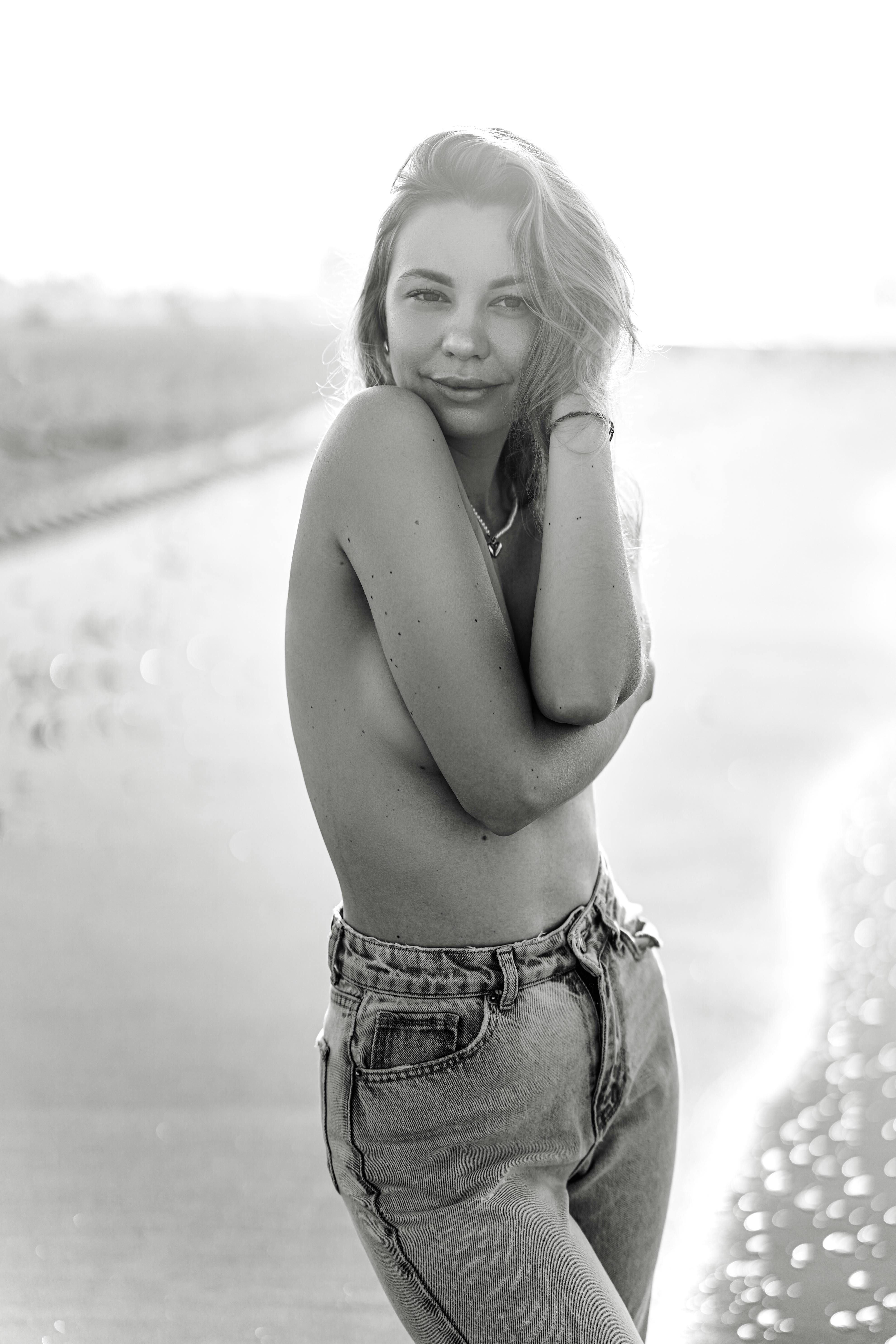 a black and white photo of a woman in jeans