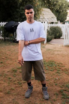 Portrait of a man wearing casual attire outdoors in a relaxed setting.