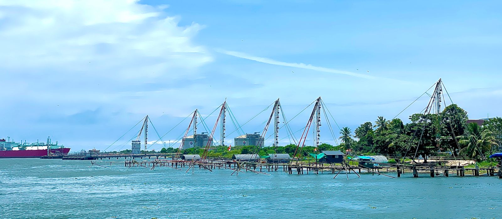 Traditional Chinese fishing nets line the waterfront in Cochin, India on a bright summer day. — flights from Coimbatore to Kochi